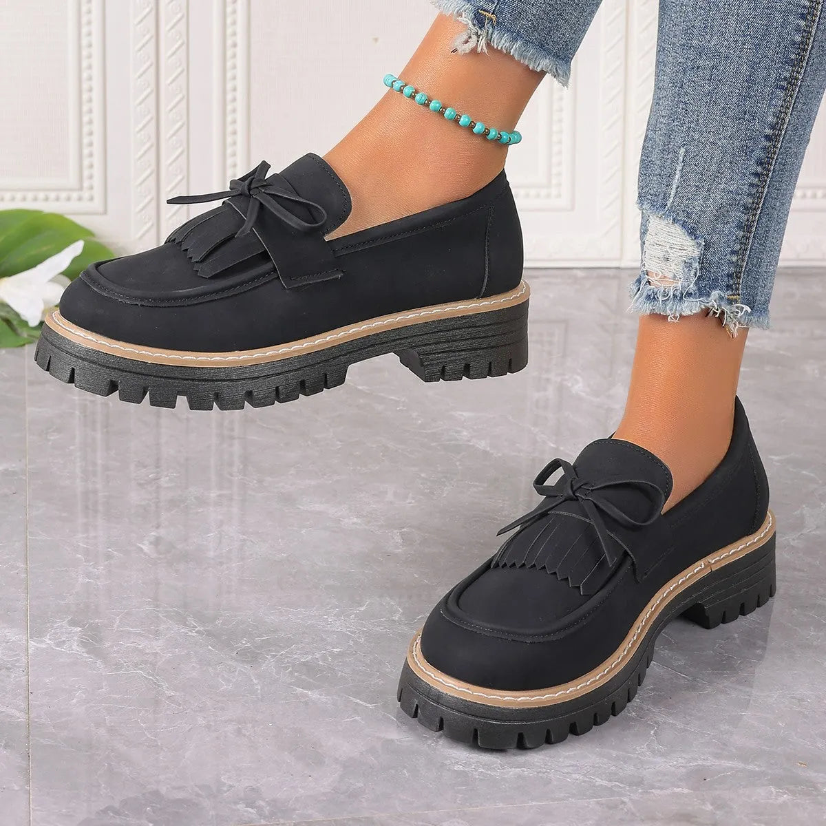 Black plus size women's loafers with tassel detail, bowknot, and a chunky low heel.