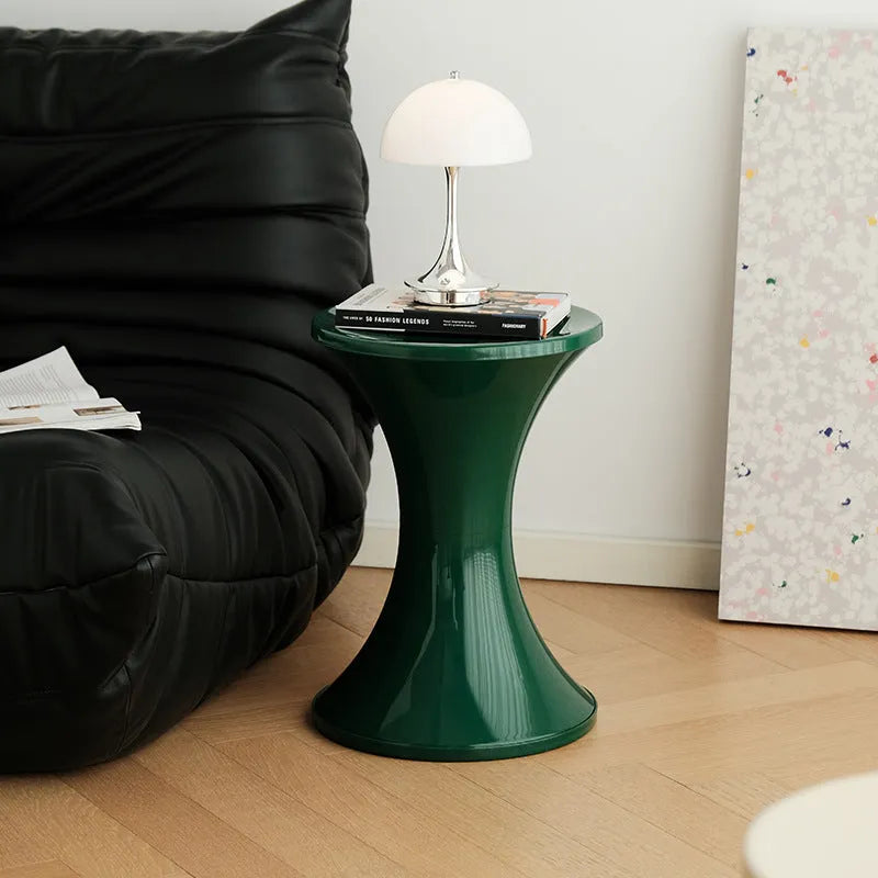 A plastic hourglass-style shoe changing stool shown in one of five available colours: black, green, red, white, or brown.