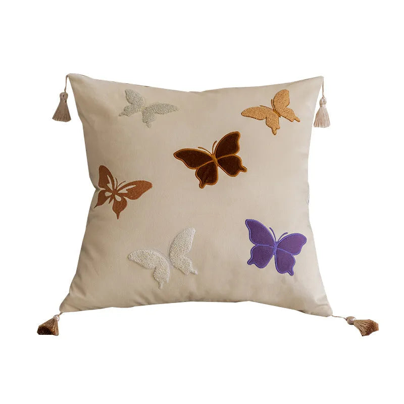 Square beige, black, and purple cushion with Chinese style embroidered butterfly pattern.
