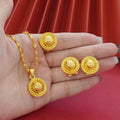 Gold-plated jewellery three-piece set with flower design pendant, matching earrings, and ring on display
