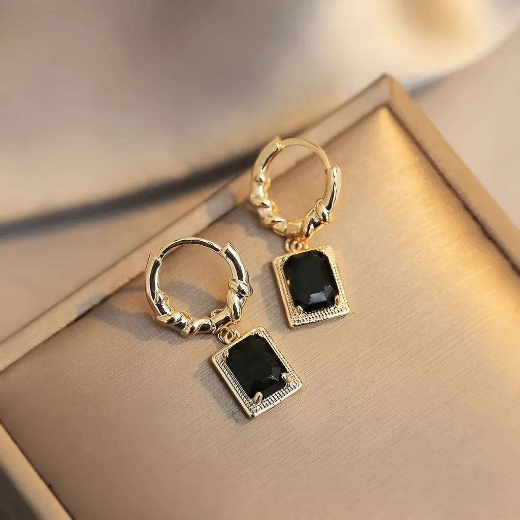 Pair of black geometric French court earrings with zircon stones on copper.