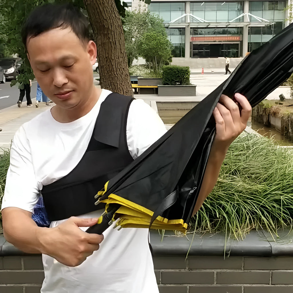 Black portable umbrella shoulder strap holder supporting an open manual folding umbrella.