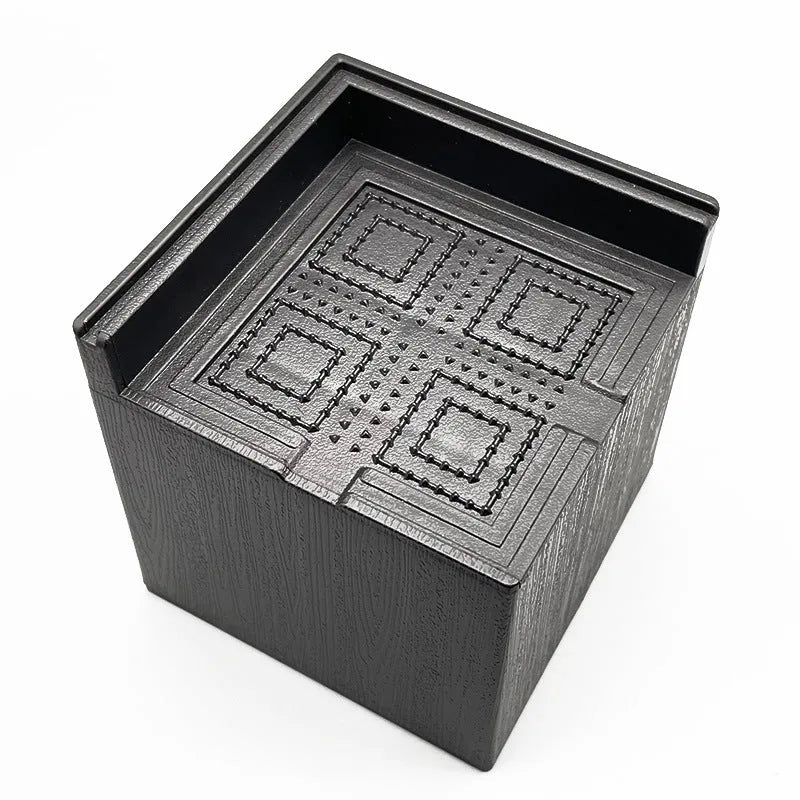Four black plastic bed foot mats for furniture height adjustment and floor protection