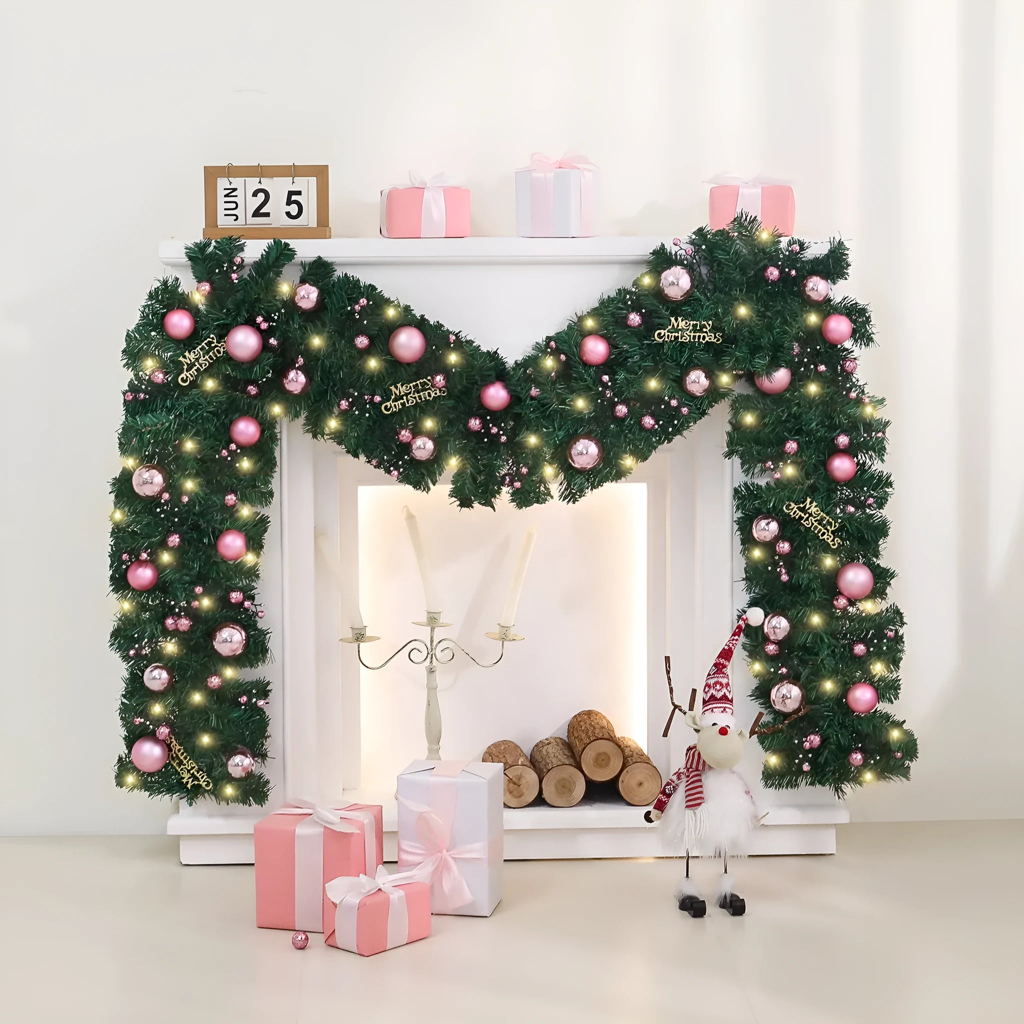 Pink artificial Christmas rattan vine decoration with small fruit clusters and warm white LED lights, coiled on a table.