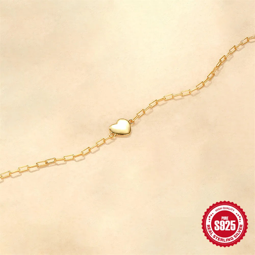 Gold tone S925 sterling silver bracelet with heart charm and clip chain closure