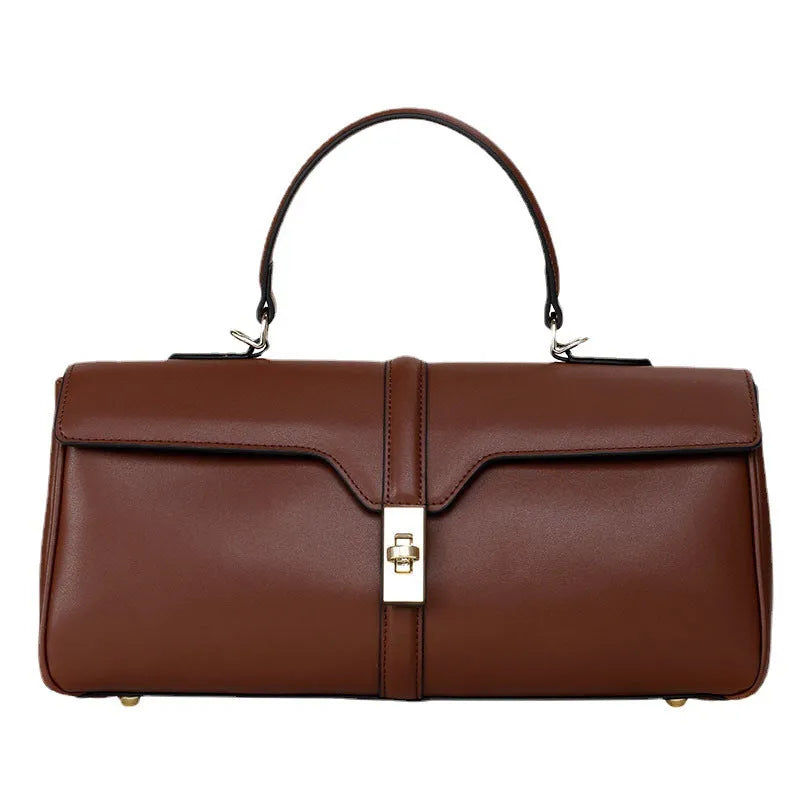 Women's cylindrical black cowhide messenger bag showing internal organiser compartments