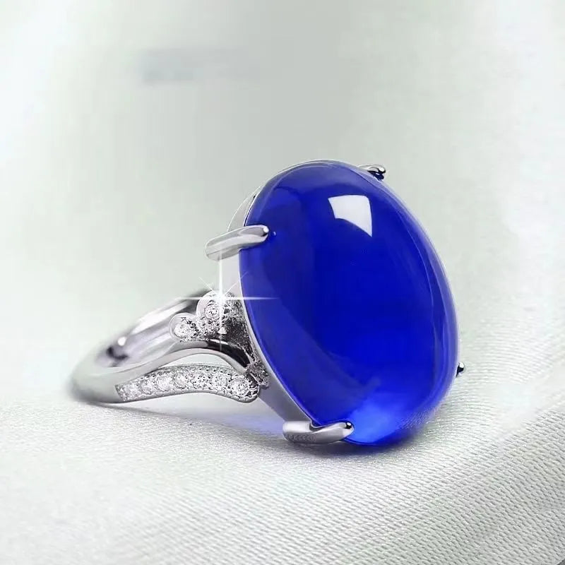 Geometric adjustable alloy ring on a hand, shown in blue finish.