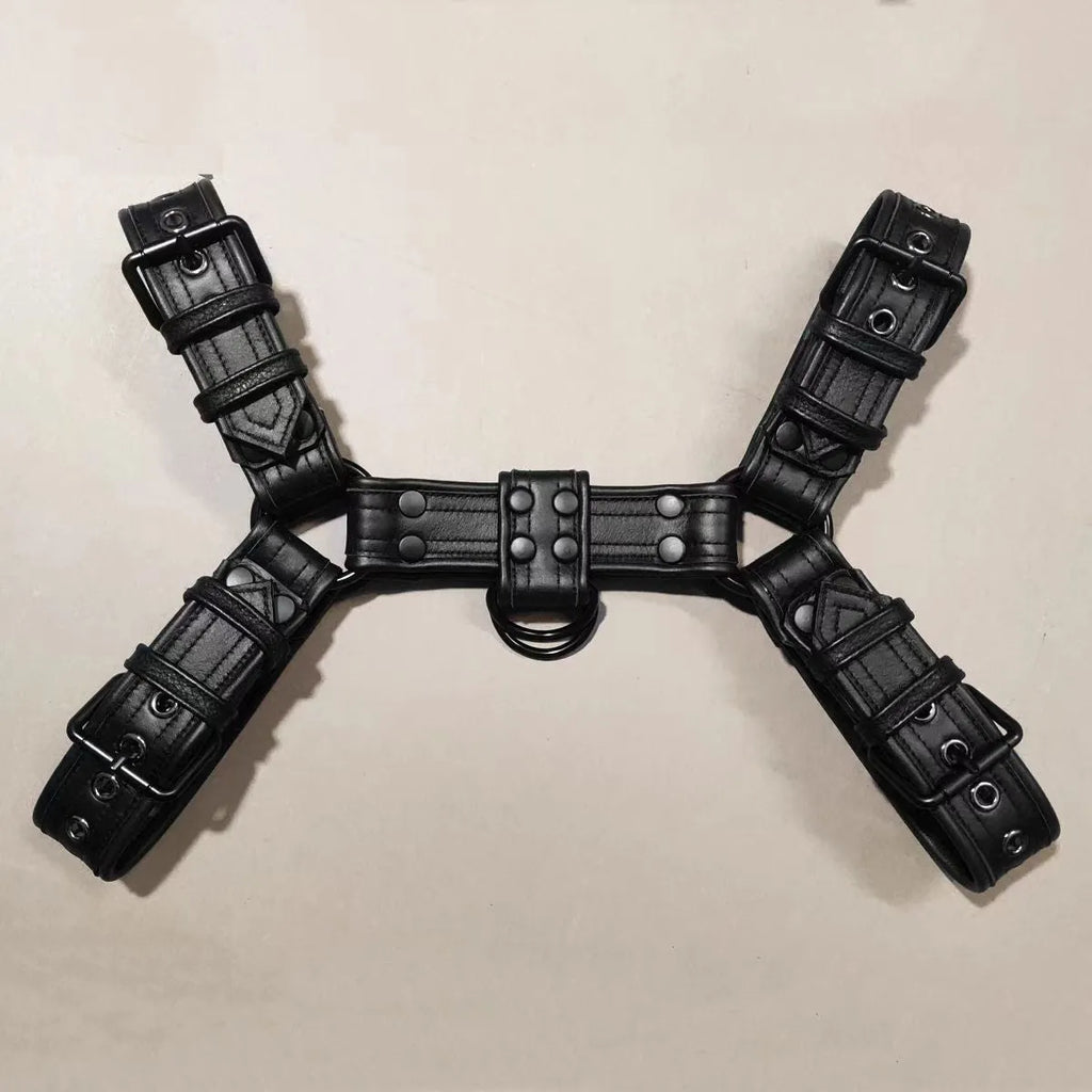 Black leather chest bondage strap with metal buckle and rivet detail on a mannequin