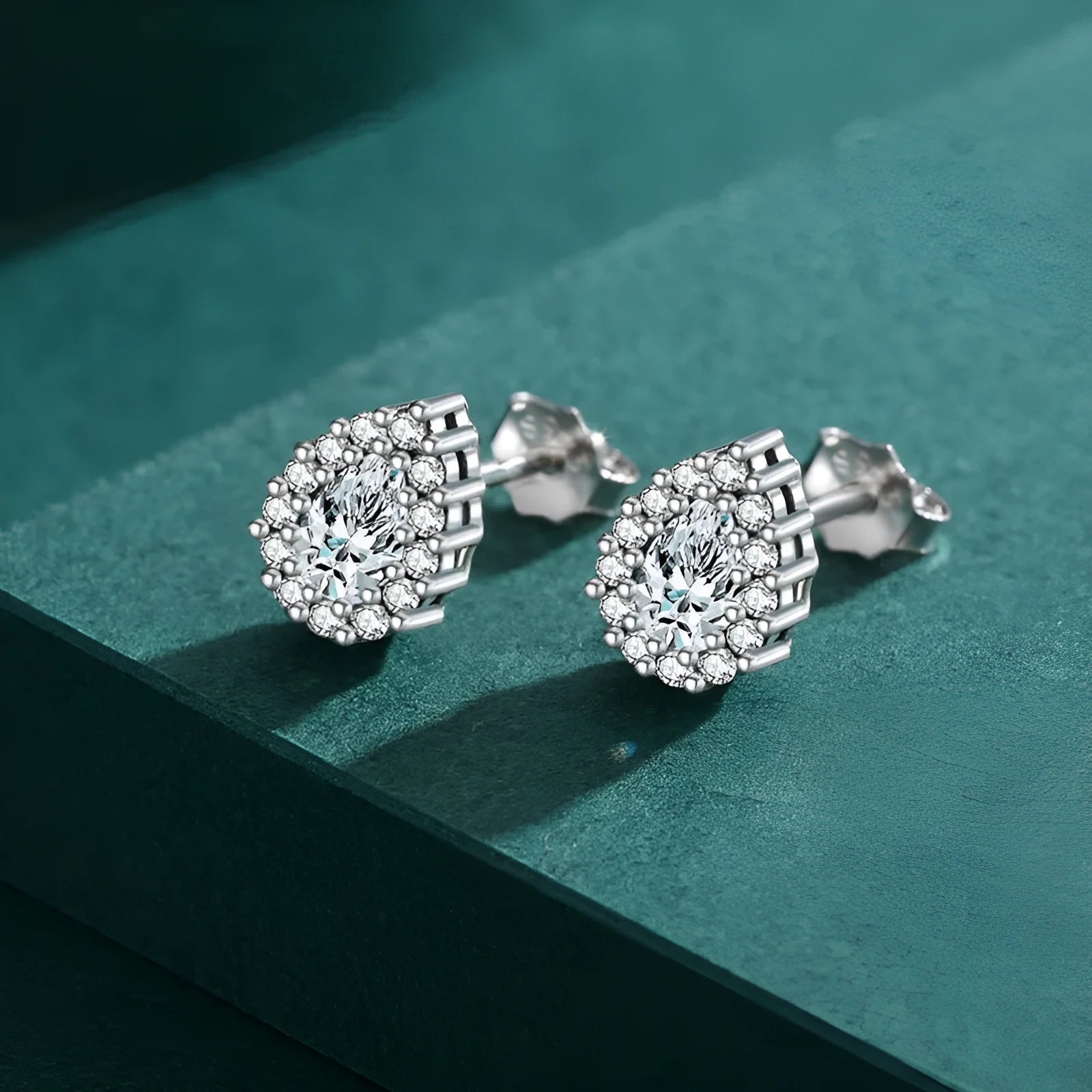 A pair of women's silver drop ear studs with a diamond-cut sparkling finish.