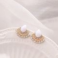 Women's silver retro fan-shaped earrings with opal and rhinestone details on a white background.