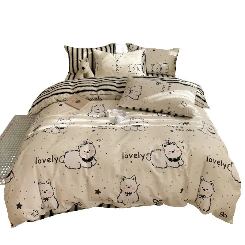 Cartoon dog print pure cotton four-piece duvet cover and bed sheet set on a bed.