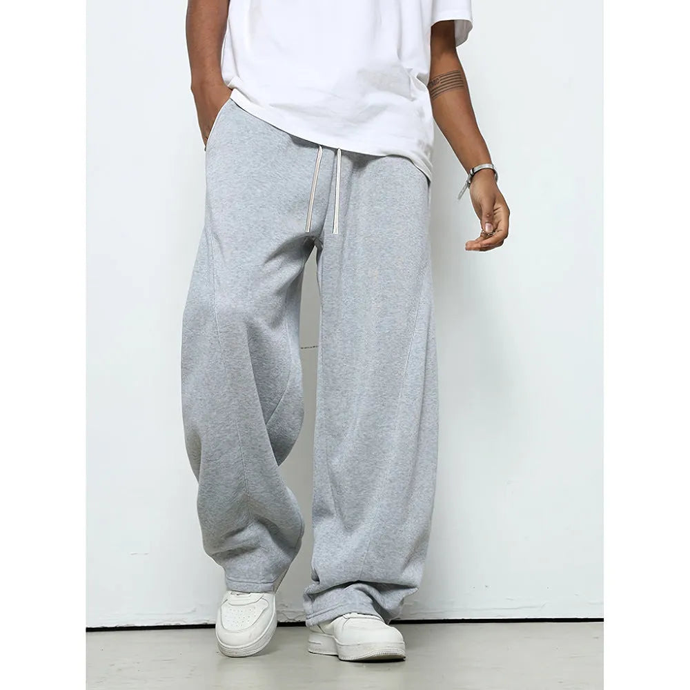 Man wearing grey micro-elastic casual trousers with a drawstring waist and straight leg.