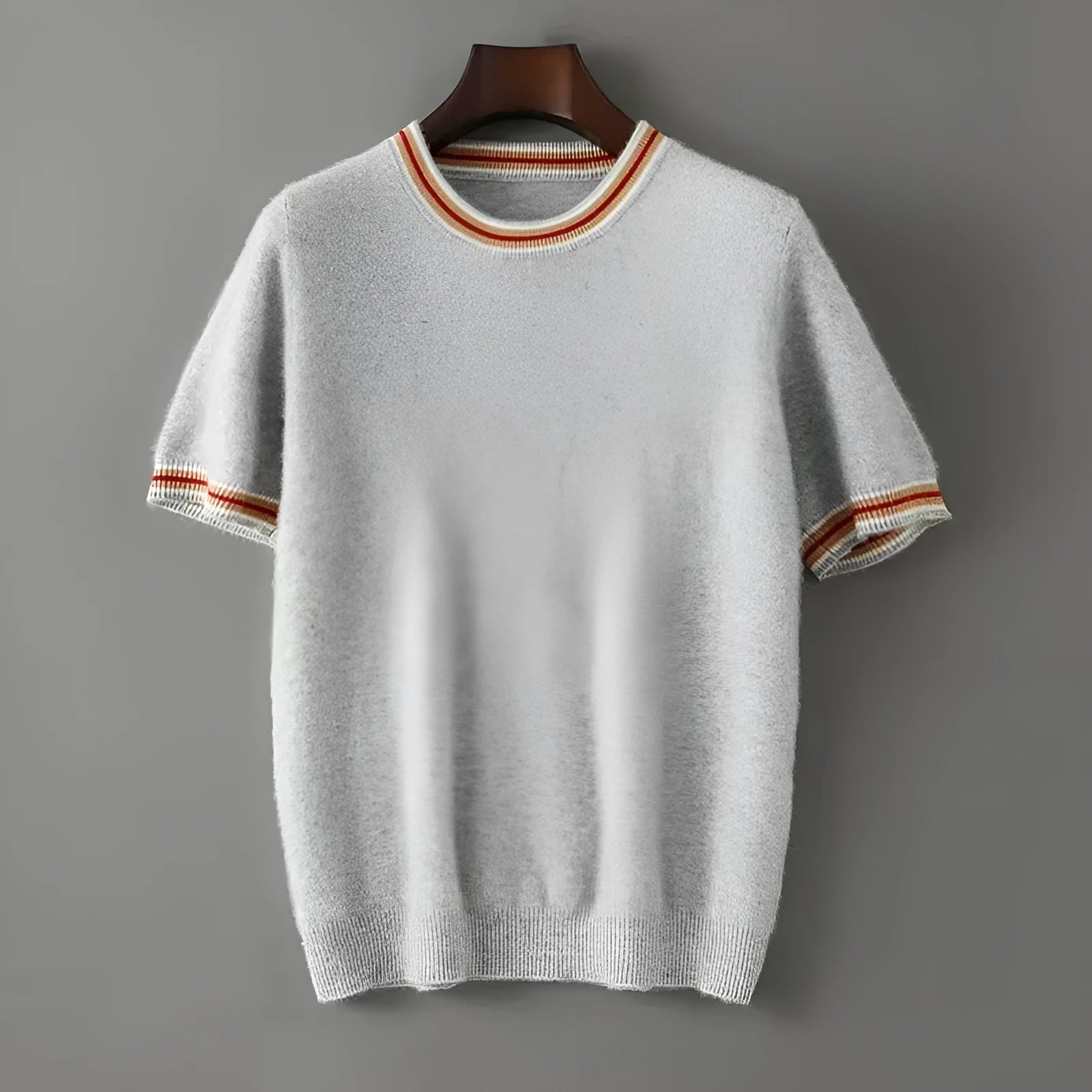 Men's short sleeve pure wool sweater in round neck pullover style on a grey background.