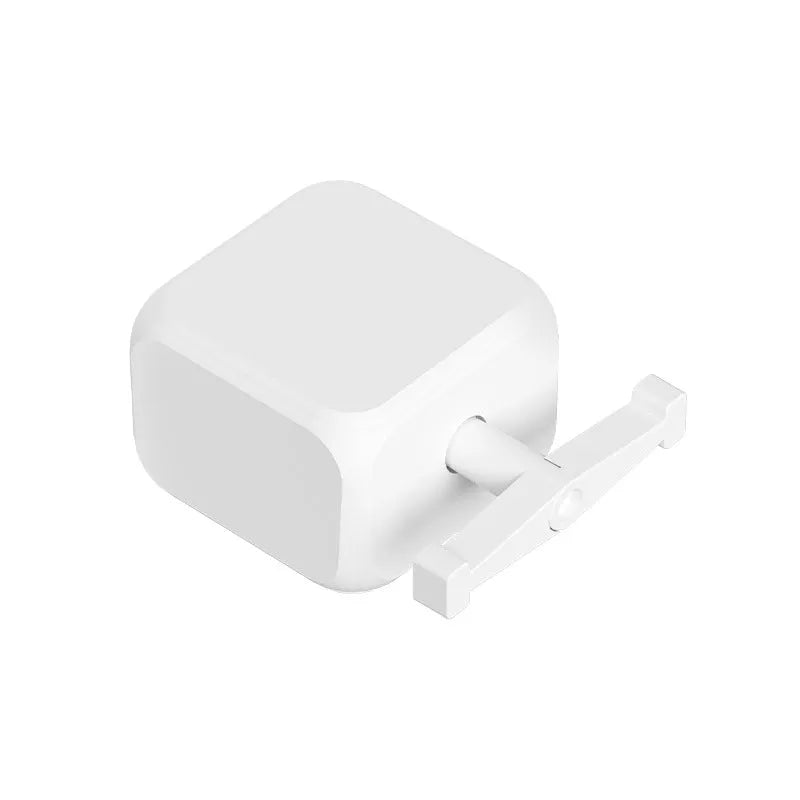 Small white Bluetooth rocker arm finger robot remote control on a surface.