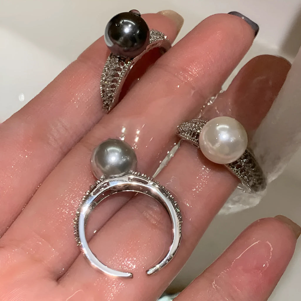 Adjustable open geometric copper ring for women with a small black pearl accent on the band.