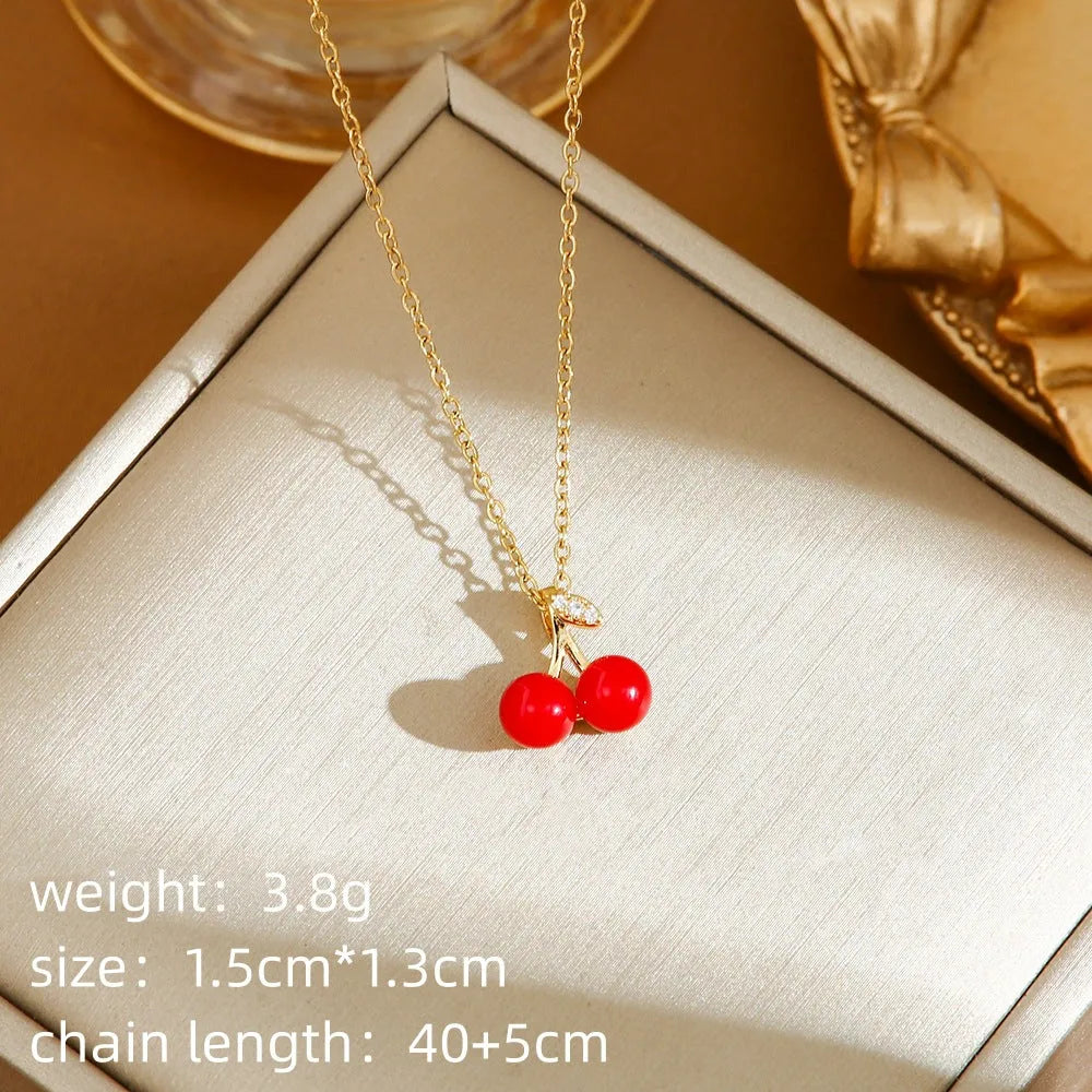 Golden titanium steel necklace with cherry, strawberry, and pepper pendant on O-ring chain.
