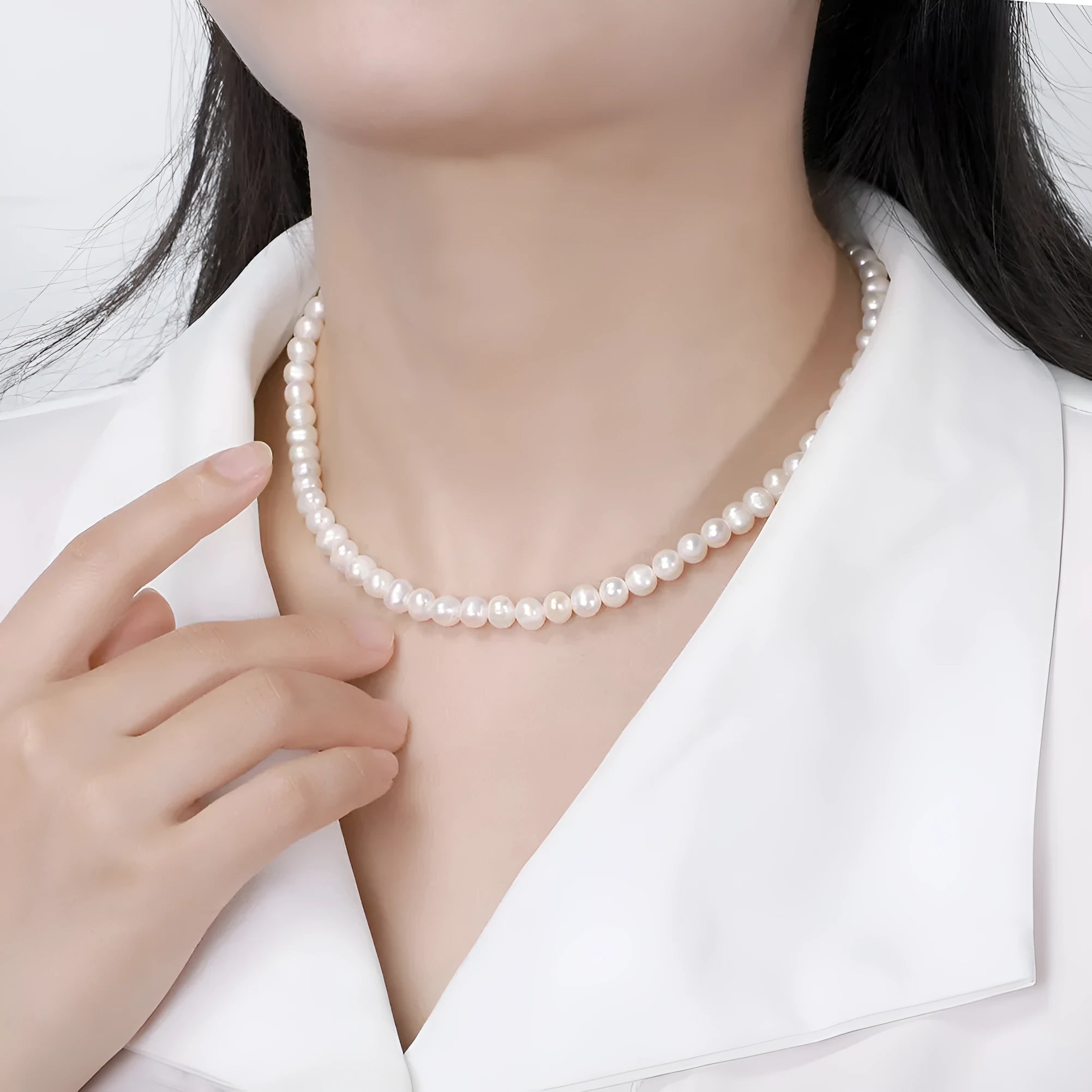 Women's adjustable silver necklace with a strand of natural freshwater pearls.