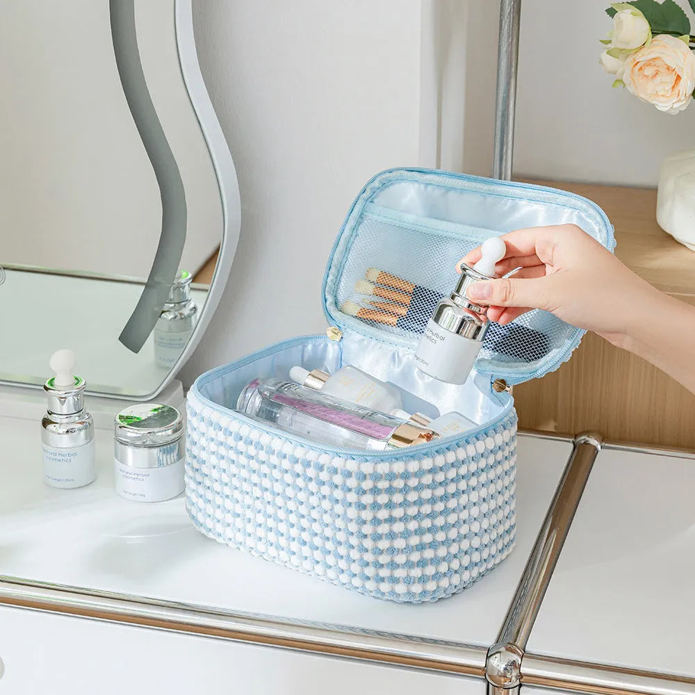 Four cube-style flannelette makeup bags in a set, shown in blue with dots colour.