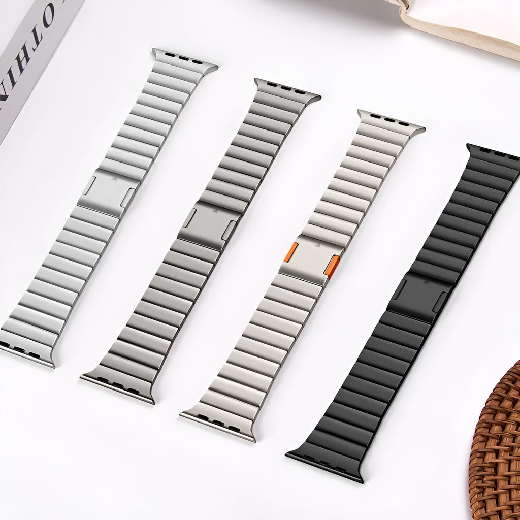 Stainless steel magnetic buckle Apple Watch strap in silver colour on a wrist.
