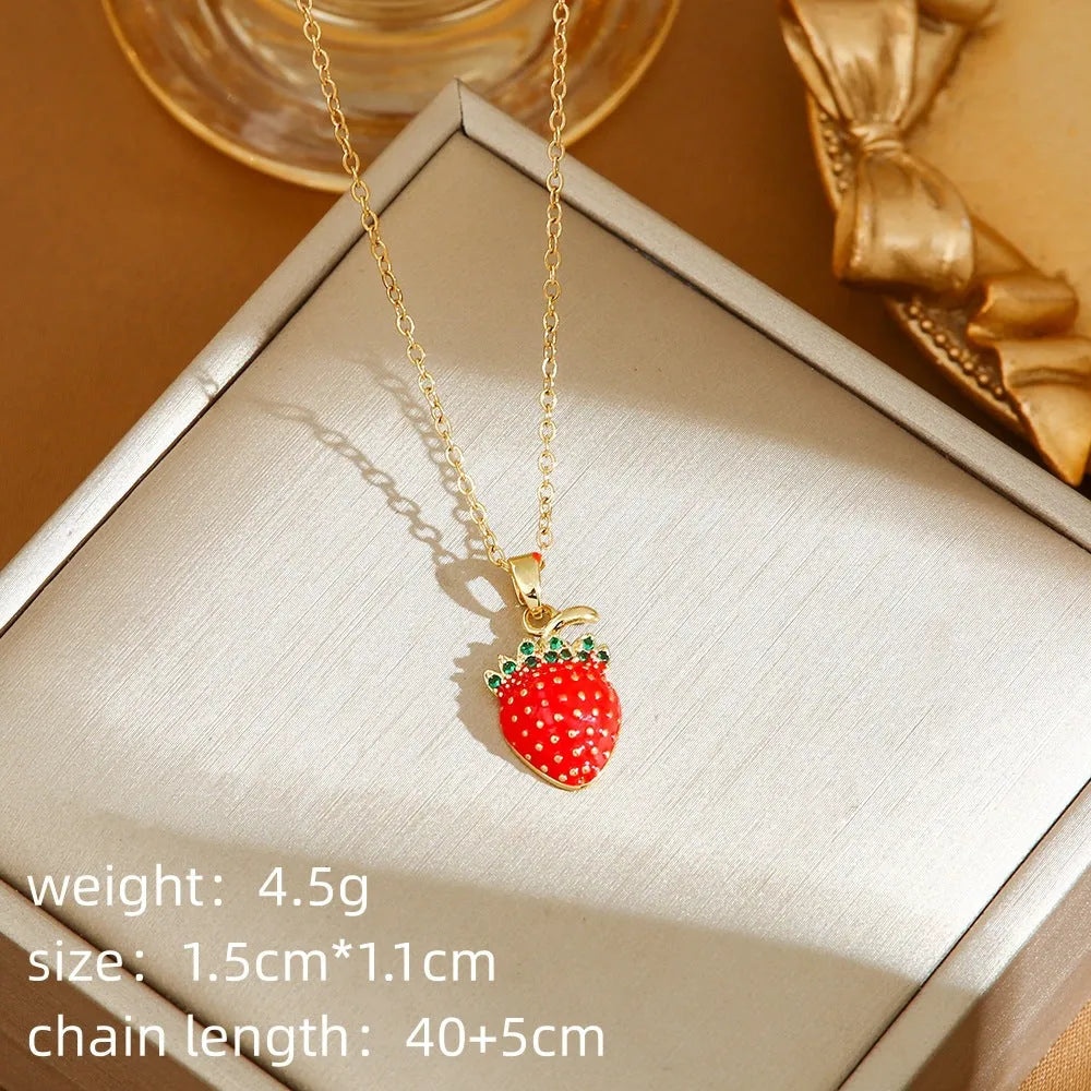 Golden titanium steel necklace with cherry, strawberry, and pepper pendant on O-ring chain.