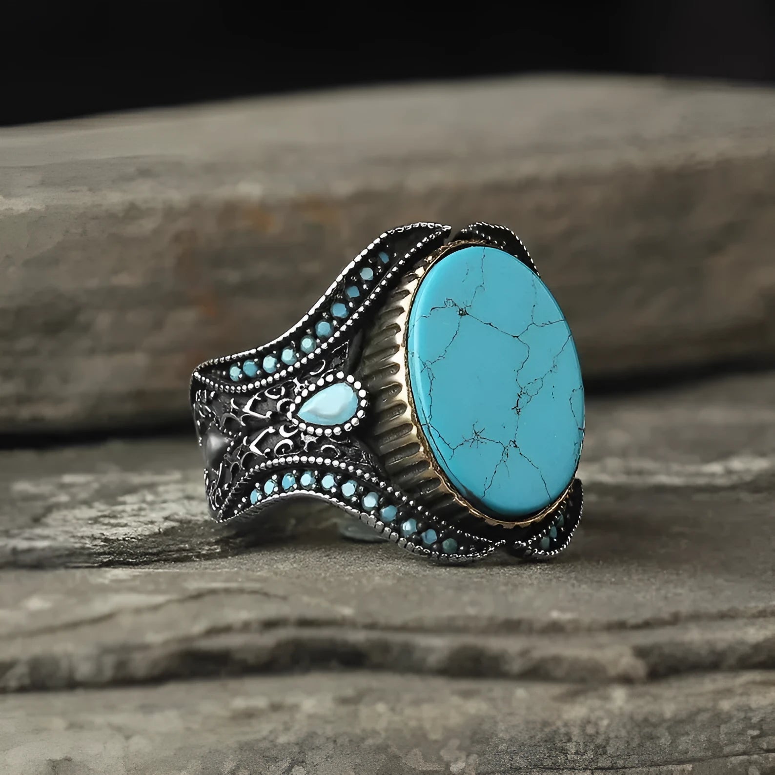 Men's antique silver ring with turquoise accent on finger showing simple round design