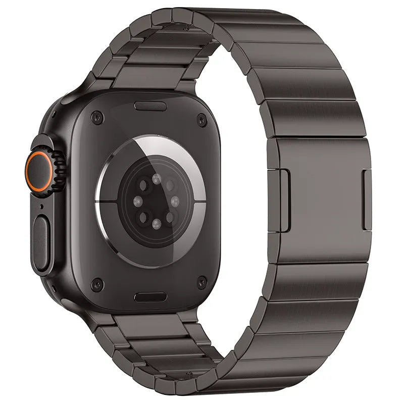 Stainless steel magnetic buckle Apple Watch strap in silver colour on a wrist.