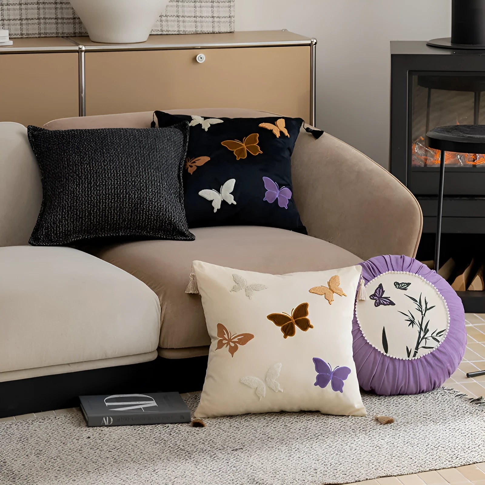 Square beige, black, and purple cushion with Chinese style embroidered butterfly pattern.