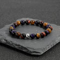 Handmade geometric tiger-eye stone bracelet with elastic cord in yellow, purple, and red colour options