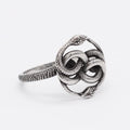 A titanium steel men's snake ring in steel colour showing a detailed twisted retro design on a finger.