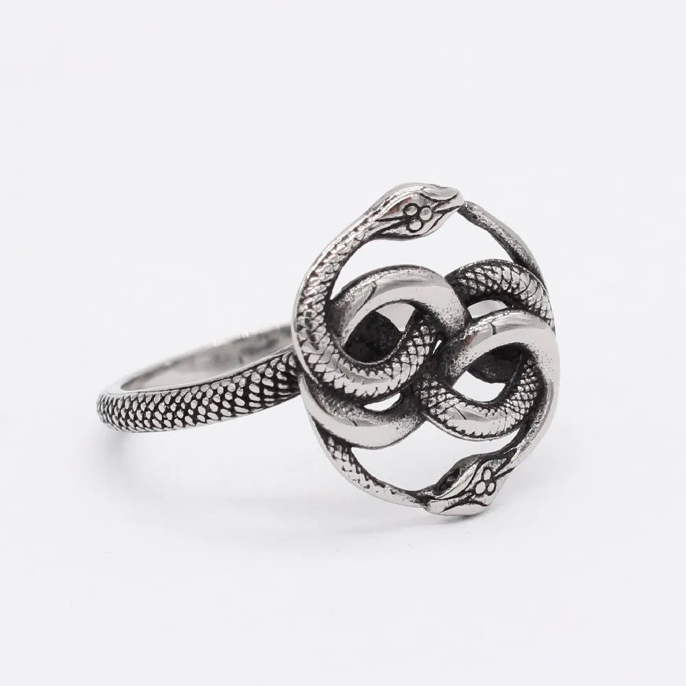 A titanium steel men's snake ring in steel colour showing a detailed twisted retro design on a finger.
