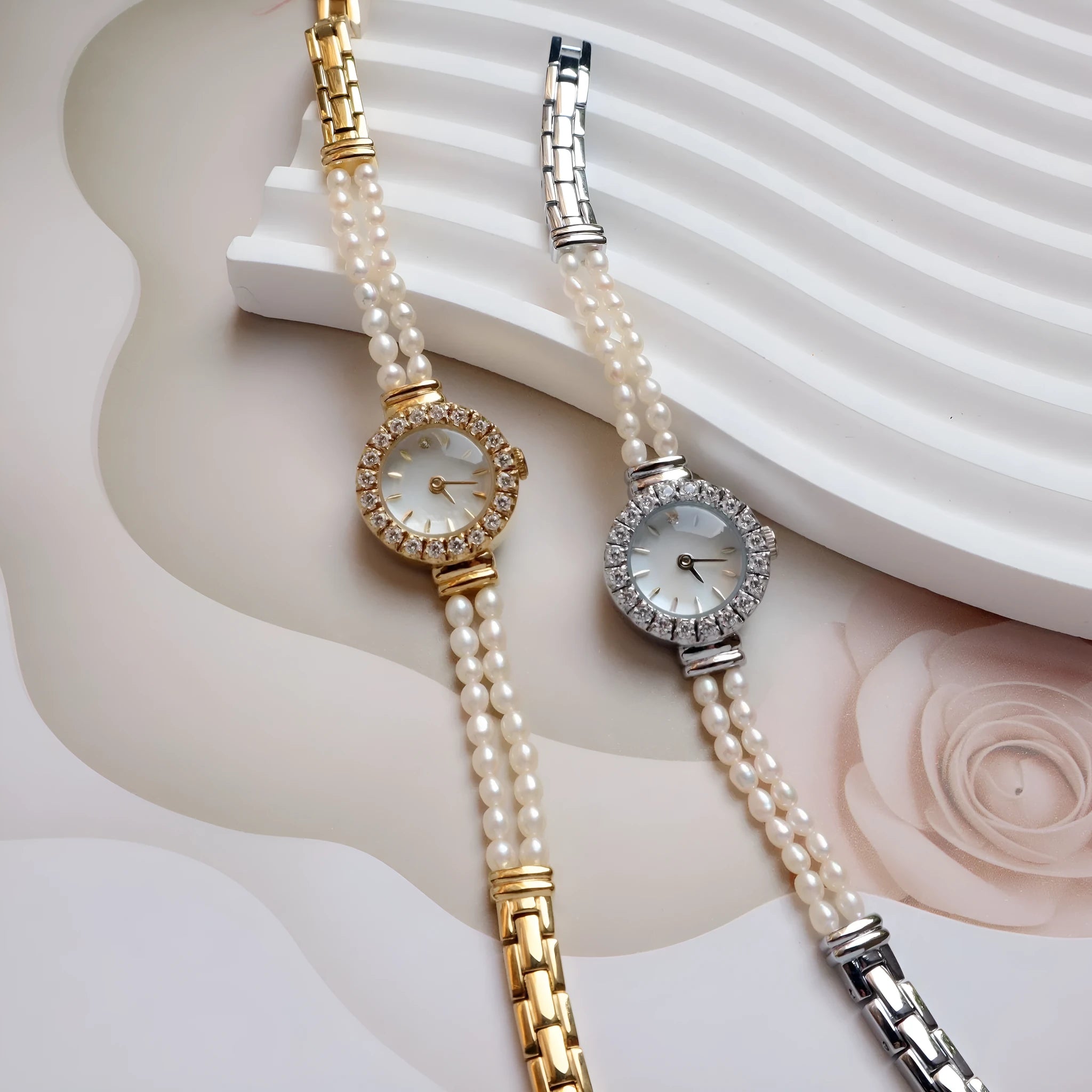 Light gold women's watch with a stainless steel strap featuring integrated freshwater pearls and a round white dial.