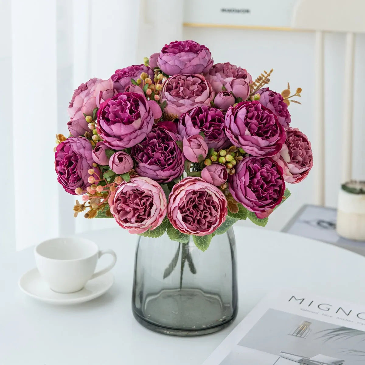 Artificial silk peony bouquet in champagne colour on a table.