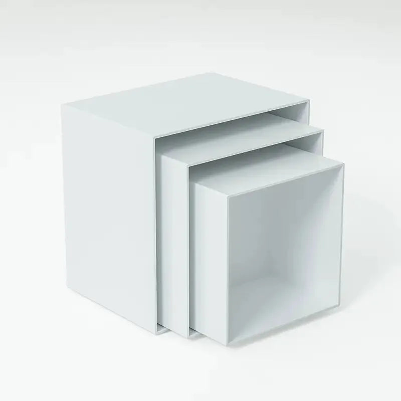 Six white modular plastic cube units arranged as a tiered dessert display stand holding cupcakes.