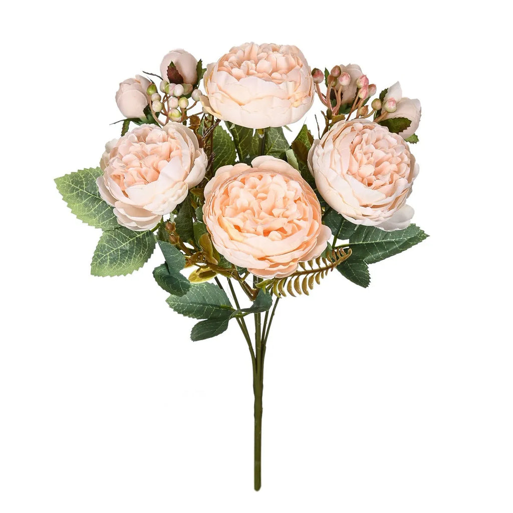 Artificial silk peony bouquet in champagne colour on a table.