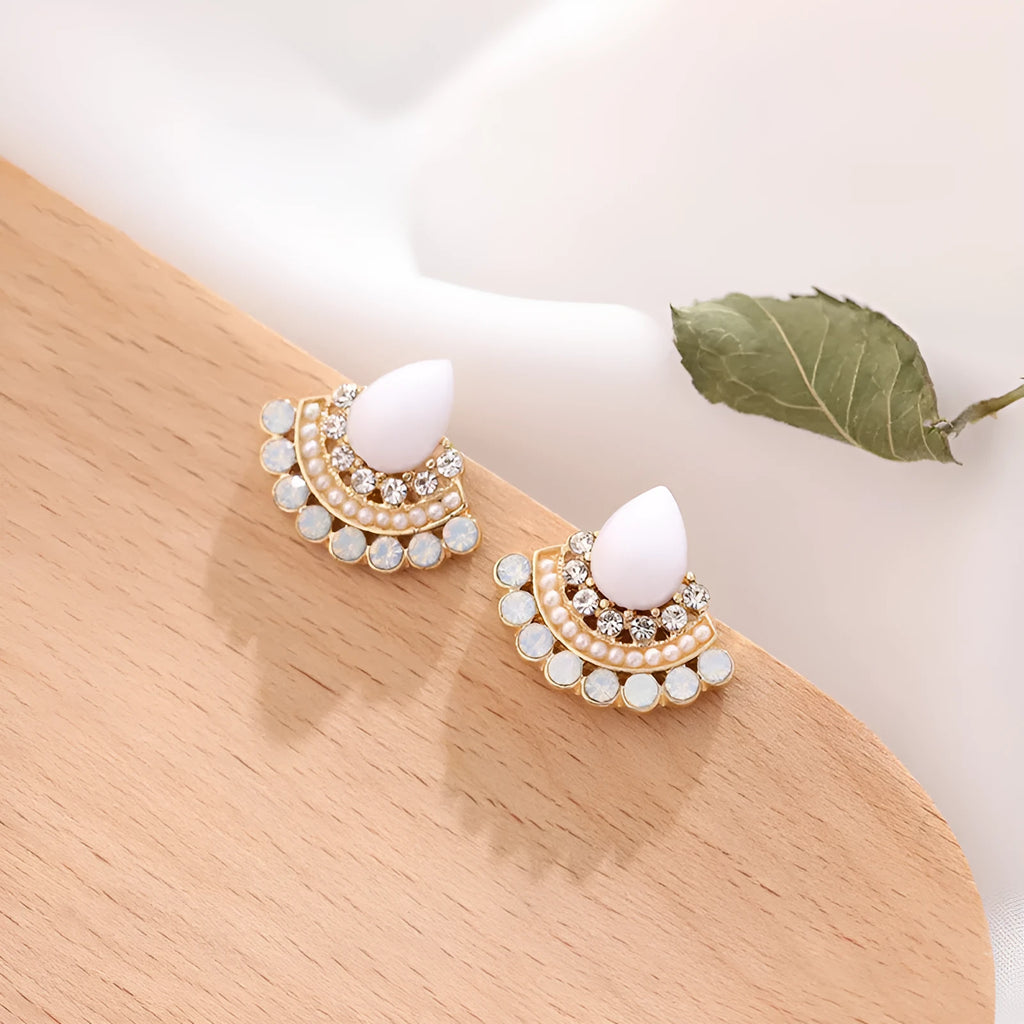 Women's silver retro fan-shaped earrings with opal and rhinestone details on a white background.