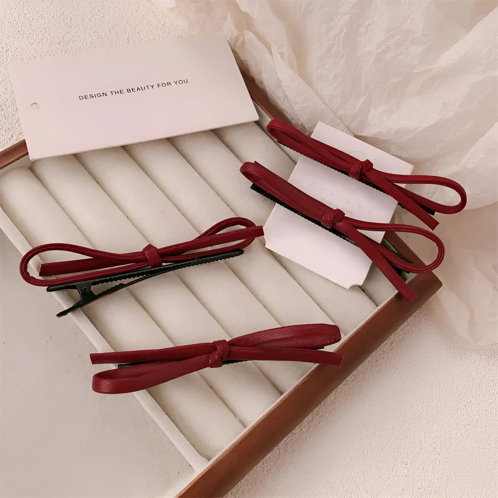 Wine red genuine leather bow hair clip barrette on a white background.