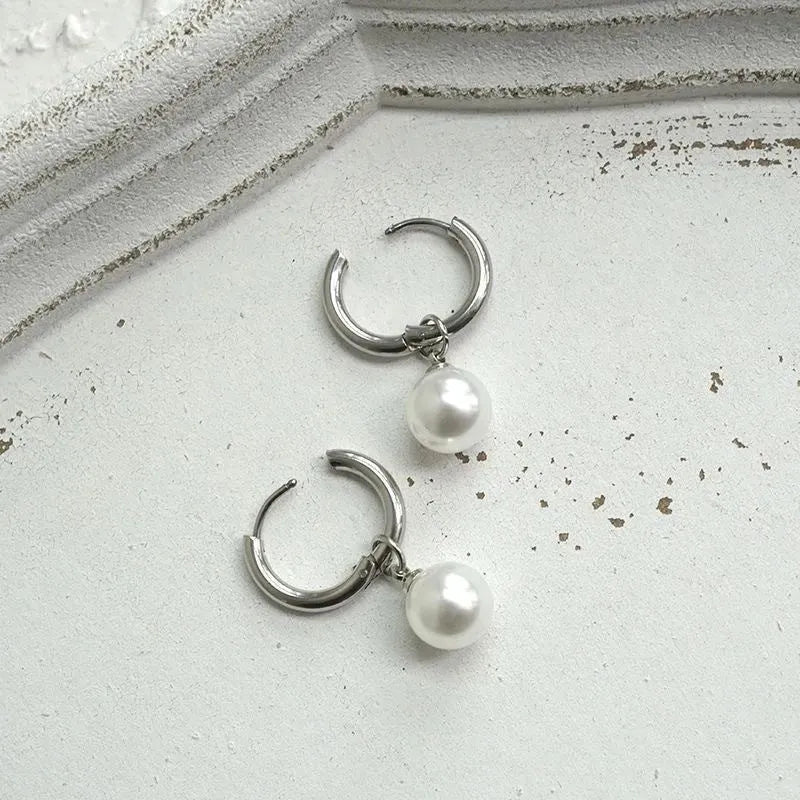 Women's geometric pearl earrings with round elements and titanium steel alloy construction