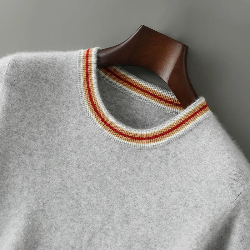 Men's short sleeve pure wool sweater in round neck pullover style on a grey background.
