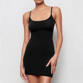 Black sleeveless sling sheath dress on a hanger, showing its mid waist and short skirt.