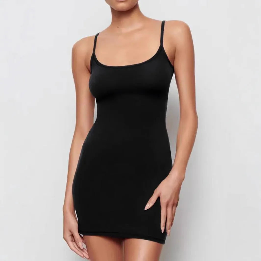 Black sleeveless sling sheath dress on a hanger, showing its mid waist and short skirt.