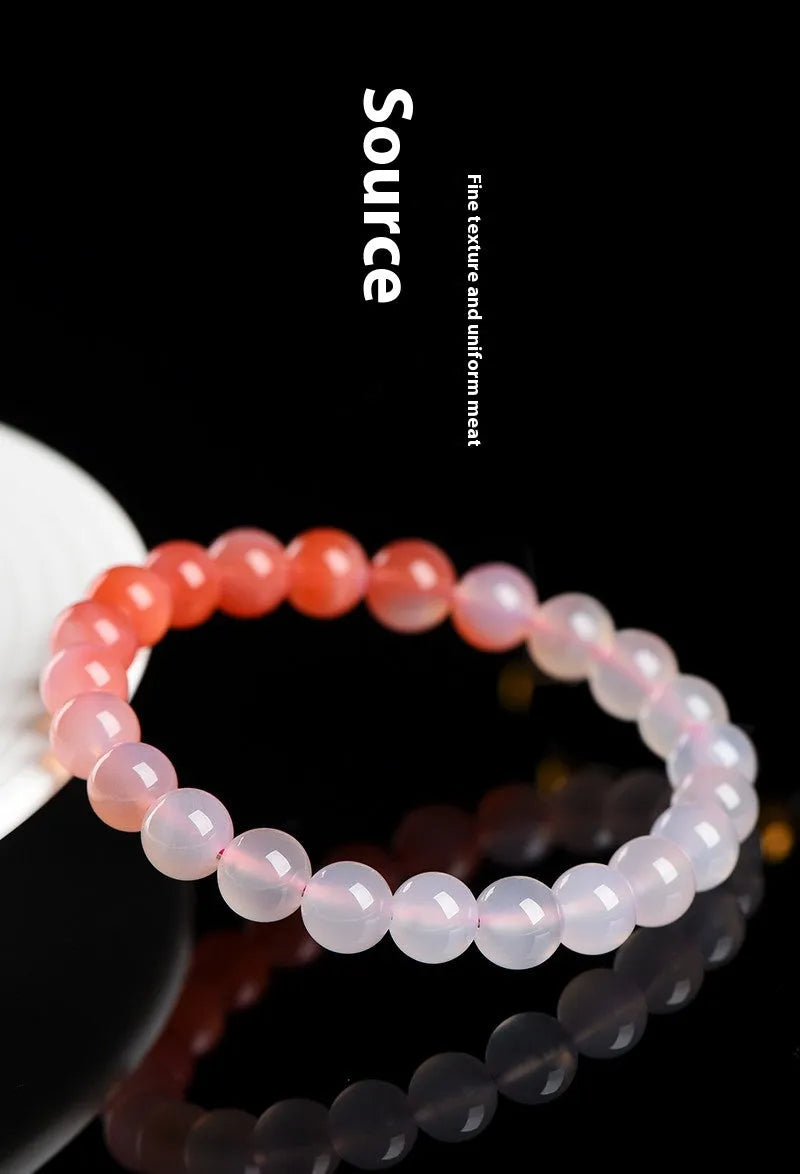 Natural gradient Yanyuan agate bracelet with geometric cut beads on a wrist.