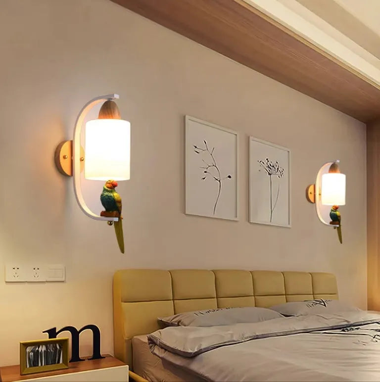 Resin bird wall lamp with iron body, wood accent, and glass lampshade on a wall
