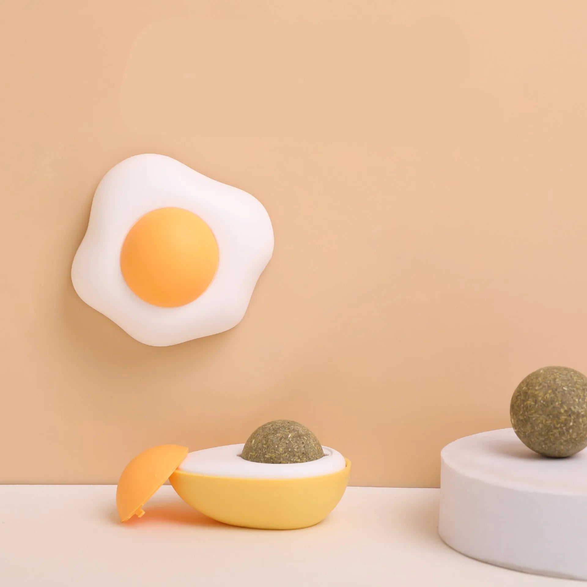 Interactive catnip ball toy in fried egg or poached egg shape with cute cat head design