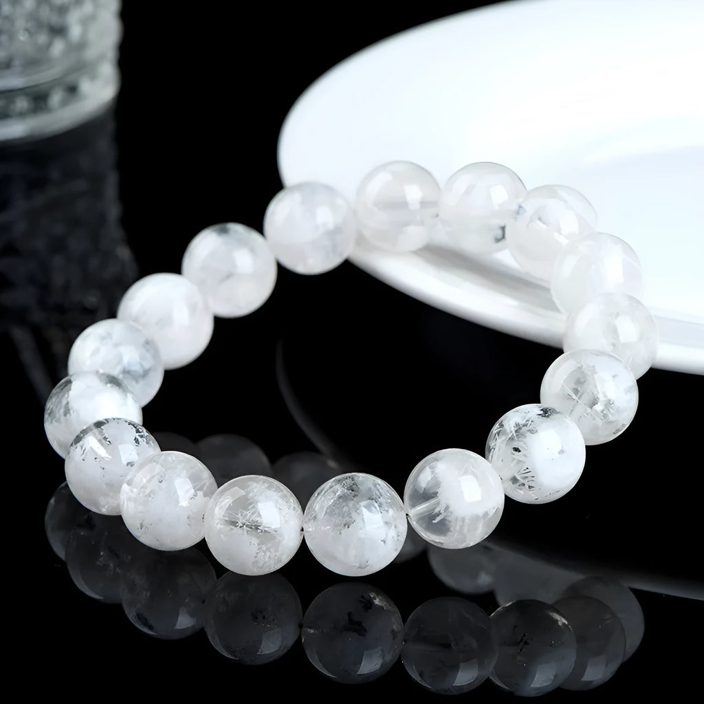 Geometric natural blizzard snowflake crystal women's bracelet with round beads on a white background.