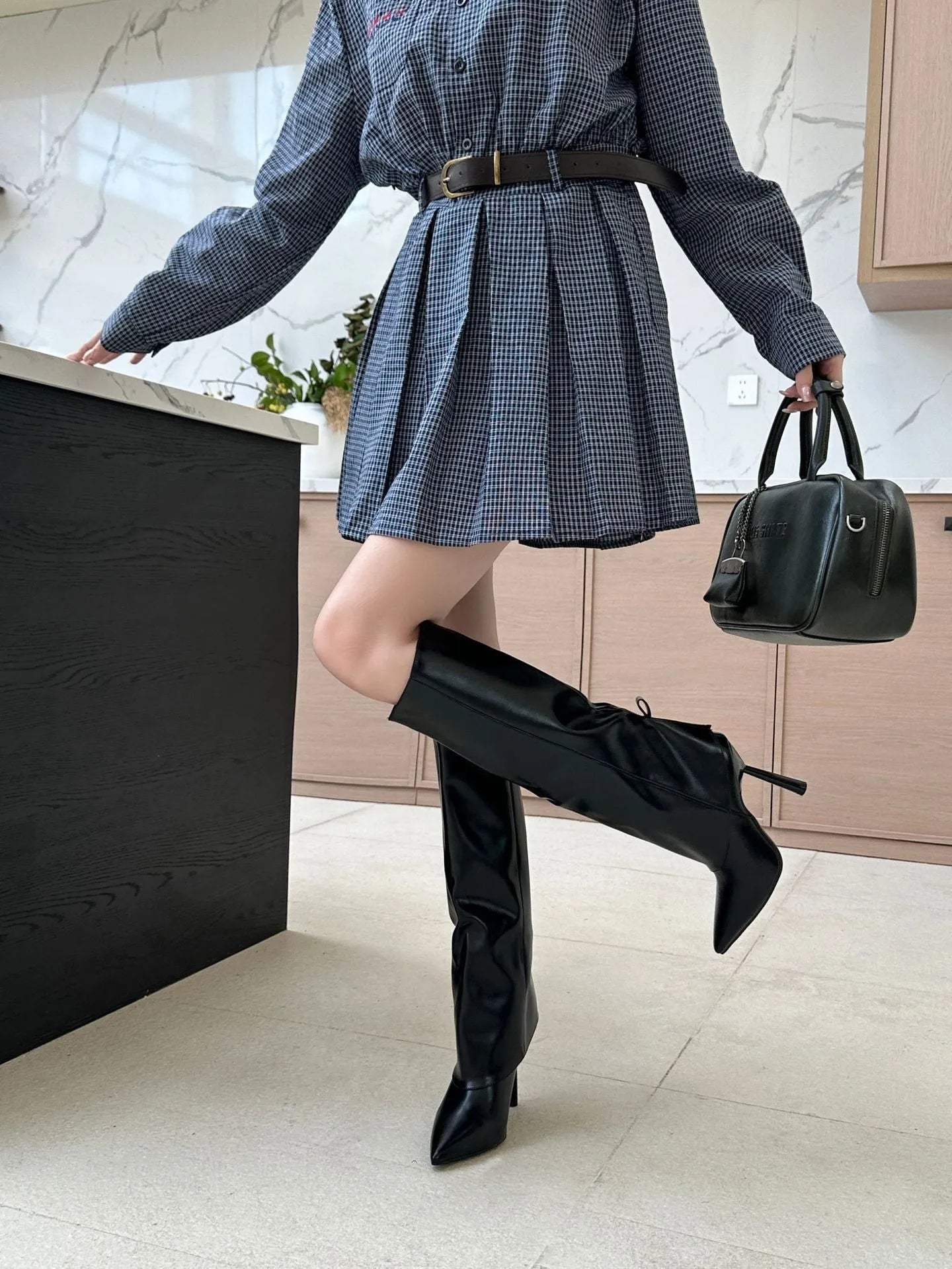Black slimming leg warmer oversleeve boots with a stiletto heel and leather stitching detail.