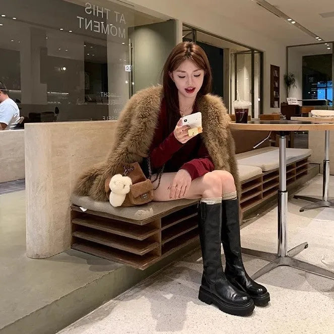 Women's black chunky heel knee-high knight boots with round toe and back zipper on a white background.