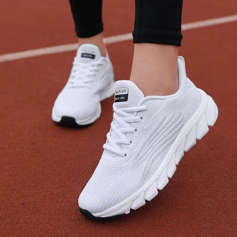 Women's low-top platform sneakers in black and white with cross-strap detail and MD sole.
