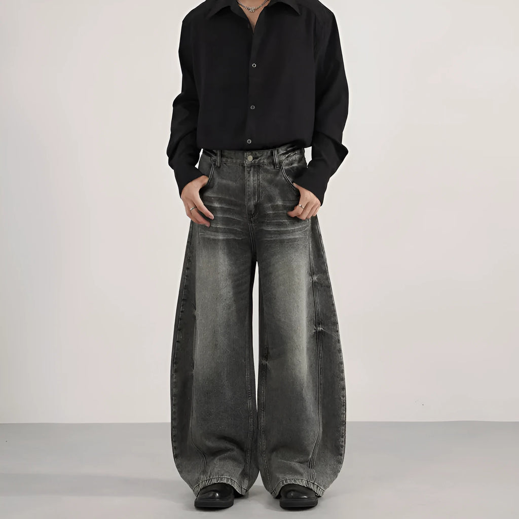 Men's loose straight washed denim jeans in black, front view showing zip fly and straight leg cut.