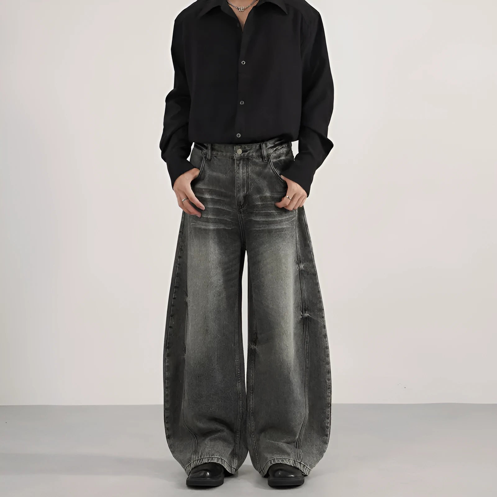 Men's loose straight washed denim jeans in black, front view showing zip fly and straight leg cut.