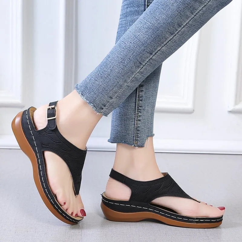 Women's red wedge heel sandals with an adjustable back strap buckle.